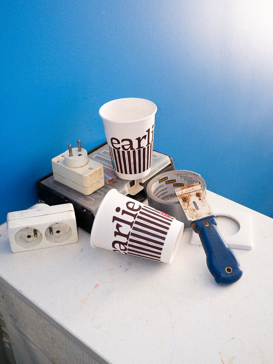 Des gobelets rayés Earlie posés sur un plan de travail, devant un mur bleu.